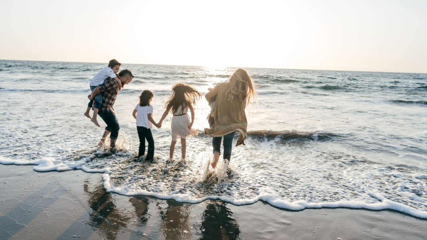 fam on beach stock